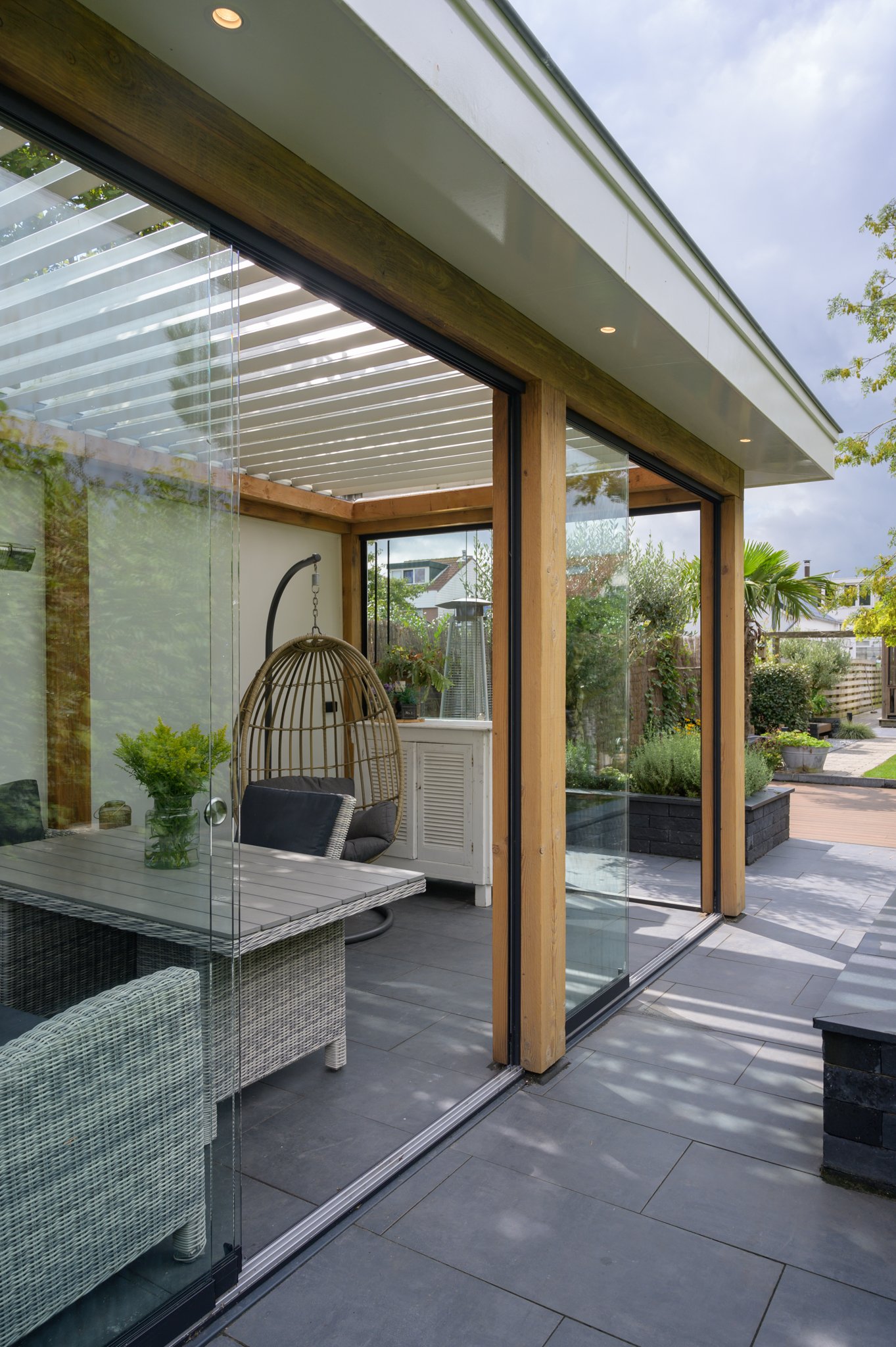 Kantelbare lamellen ingebouwd in houten veranda